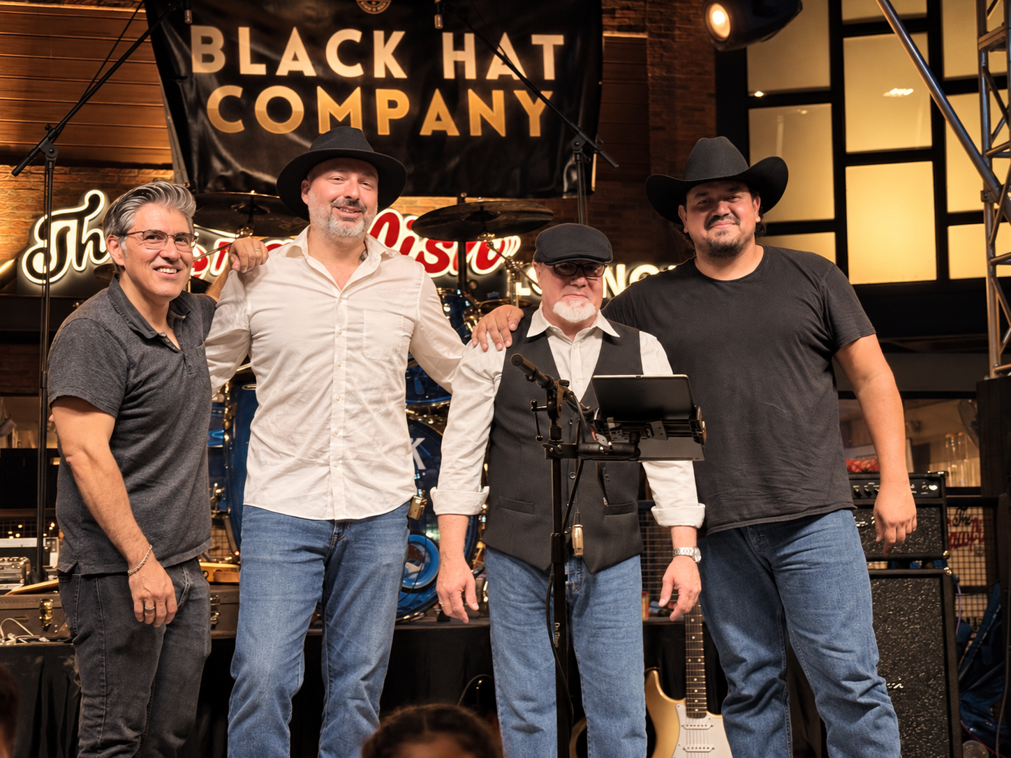 The four members of Black Hat Company together on stage